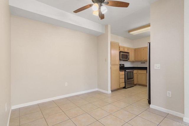 kitchen with light tile patterned floors, light brown cabinets, ceiling fan, and appliances with stainless steel finishes