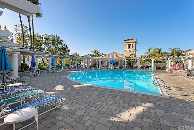 view of swimming pool with a pergola and a patio