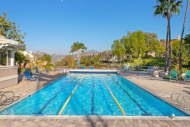 view of pool featuring a mountain view and a patio area