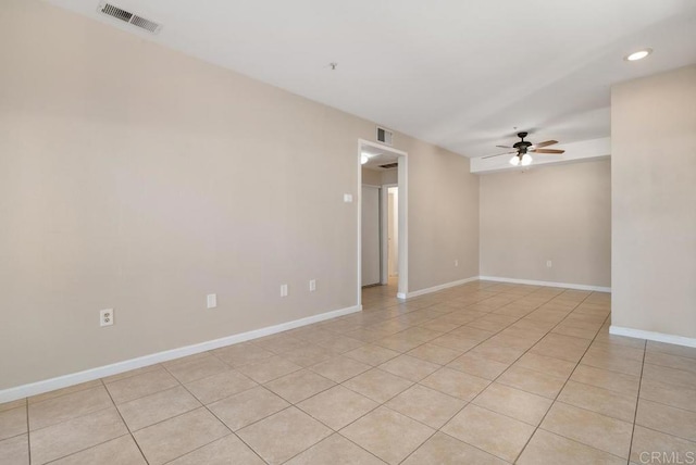 tiled spare room featuring ceiling fan