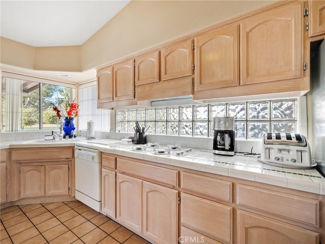 kitchen with tile countertops, white appliances, and light brown cabinets