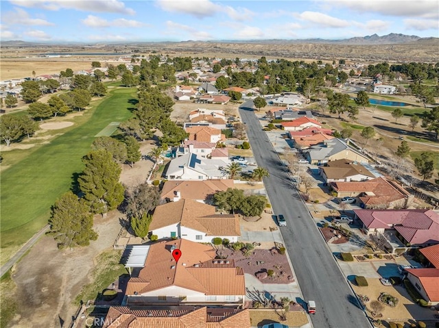 aerial view with view of golf course, a residential view, and a mountain view