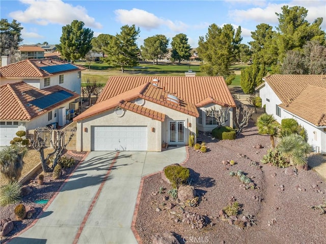 view of front of property featuring a tile roof, stucco siding, concrete driveway, fence, and a garage