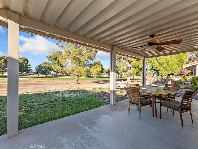 view of patio with outdoor dining area and a ceiling fan