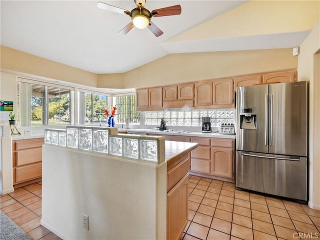 kitchen featuring light tile patterned floors, stainless steel fridge, light brown cabinets, and light countertops