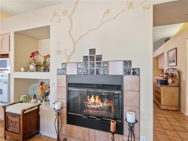 room details featuring white appliances and a tile fireplace