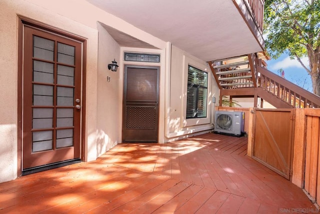 doorway to property featuring a wooden deck and ac unit