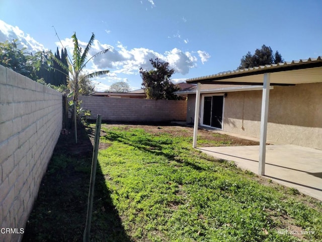 view of yard with a fenced backyard and a patio