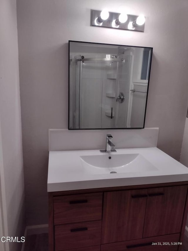 full bathroom with a stall shower and vanity