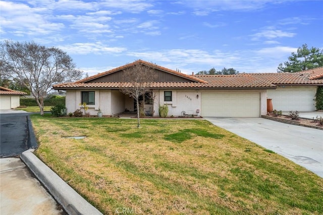 ranch-style house featuring a garage and a front lawn