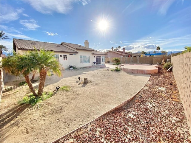 81060 Paloma Cir, Indio, CA 92201 - back of house with a patio area, a fenced backyard, a tiled roof, a chimney, and stucco siding