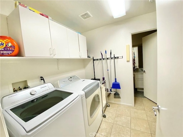 81060 Paloma Cir, Indio, CA 92201 - laundry room with washing machine and dryer, cabinet space, and light tile patterned flooring