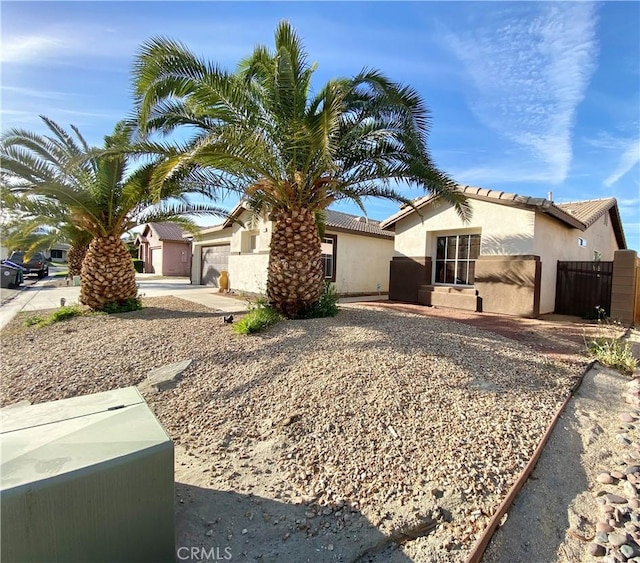 81060 Paloma Cir, Indio, CA 92201 - view of front of property with stucco siding, an attached garage, and fence