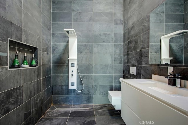 bathroom featuring vanity, toilet, tile walls, and walk in shower