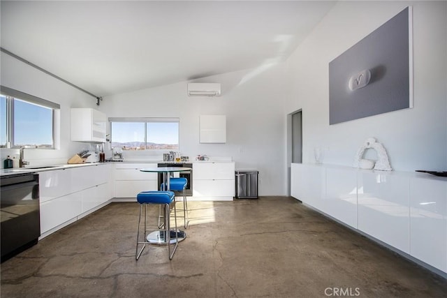 kitchen with black dishwasher, a kitchen breakfast bar, a wall mounted AC, and white cabinets