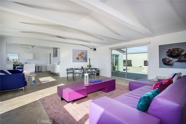 living room with vaulted ceiling with beams and concrete flooring