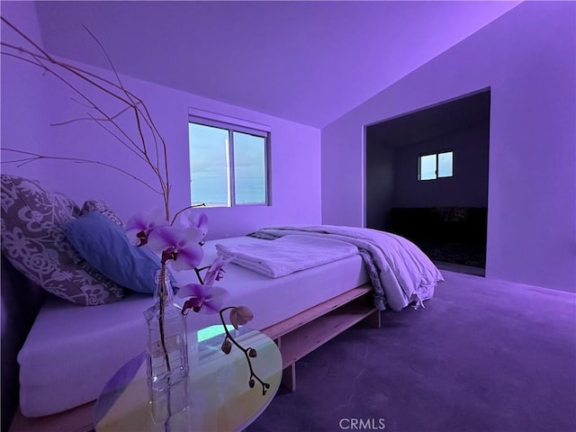 bedroom with vaulted ceiling and carpet flooring