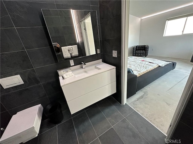 bathroom with vanity, tile walls, and tile patterned floors