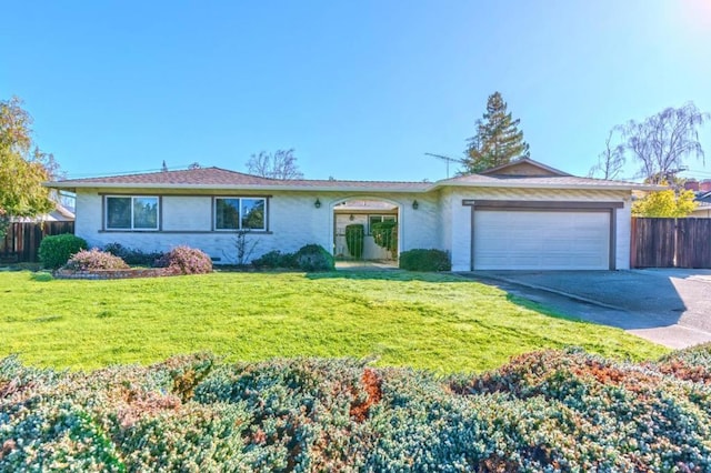 ranch-style house with a garage and a front lawn