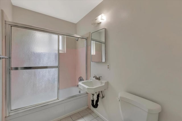 full bathroom featuring tile patterned flooring, sink, enclosed tub / shower combo, and toilet