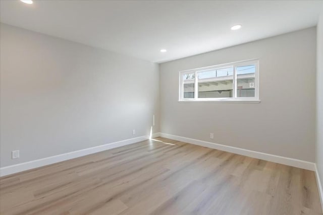 unfurnished room with light hardwood / wood-style floors