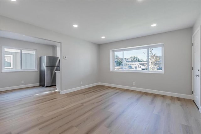 empty room with light hardwood / wood-style floors