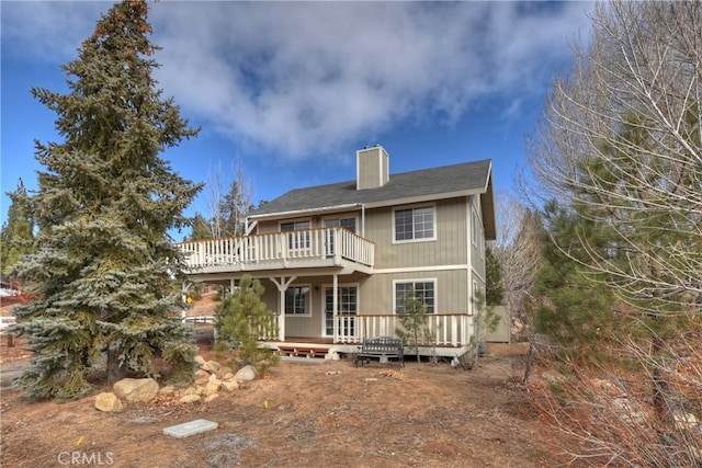 rear view of house featuring a wooden deck