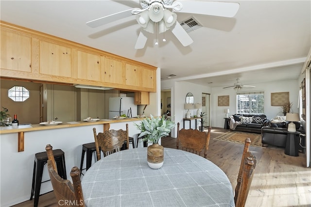 dining area featuring ceiling fan and light hardwood / wood-style flooring