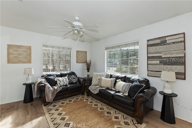 living room with hardwood / wood-style floors and ceiling fan