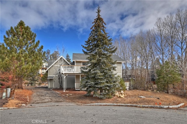 view of property hidden behind natural elements with a deck