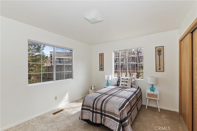 carpeted bedroom featuring a closet