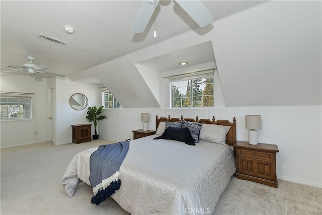 carpeted bedroom with ceiling fan and vaulted ceiling