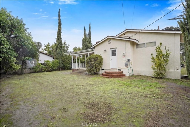 rear view of house with a yard