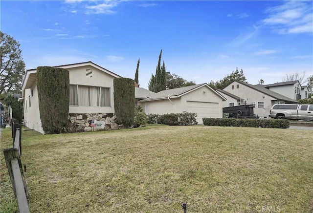 ranch-style home with a garage and a front lawn