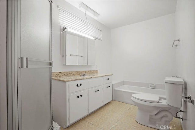 bathroom with vanity, tile patterned floors, a bathtub, and toilet