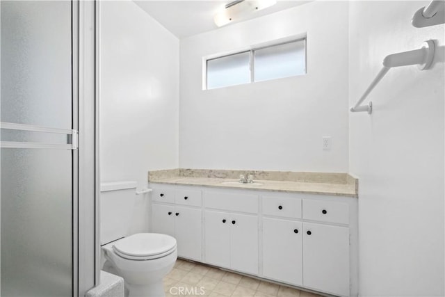 bathroom with vanity, toilet, and walk in shower