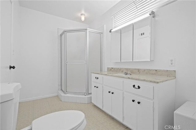 bathroom with tile patterned floors, toilet, a shower with shower door, and vanity