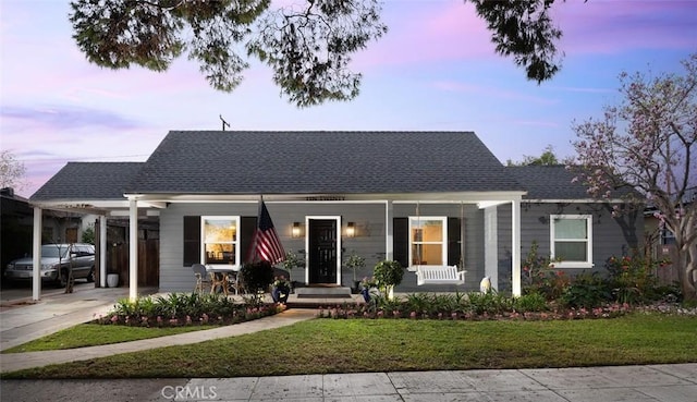 bungalow-style house with a carport and a yard