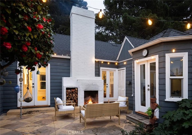 view of patio / terrace with french doors and an outdoor living space with a fireplace