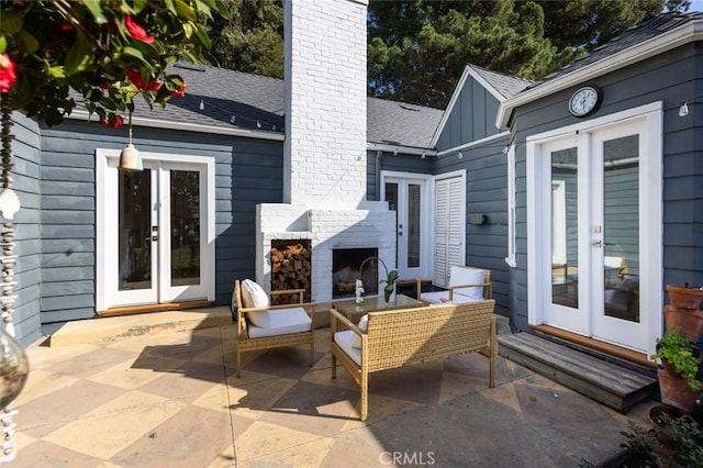 view of patio featuring an outdoor living space with a fireplace and french doors