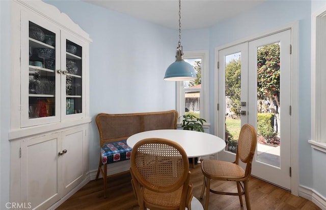 dining space with hardwood / wood-style floors and french doors