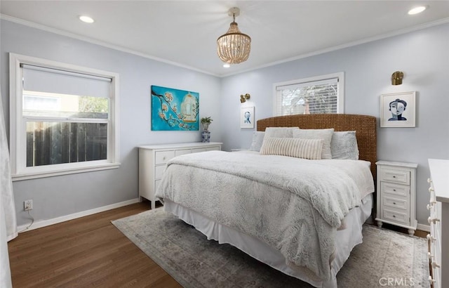 bedroom with dark hardwood / wood-style flooring, a notable chandelier, and crown molding