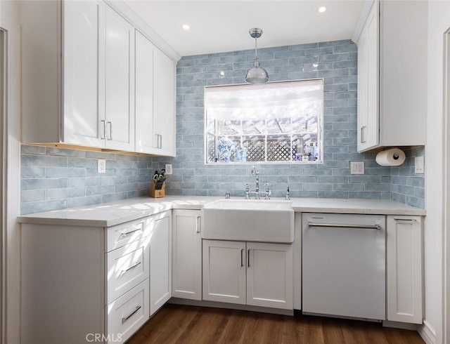 kitchen with white cabinetry, hanging light fixtures, sink, and dishwasher