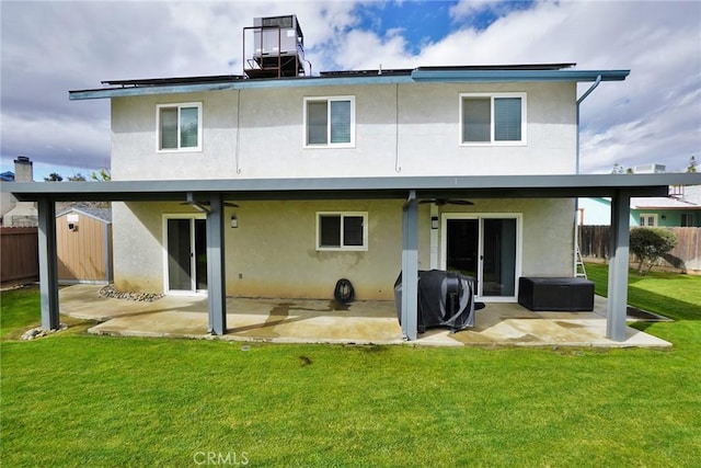 rear view of property featuring a yard, a patio, and ceiling fan