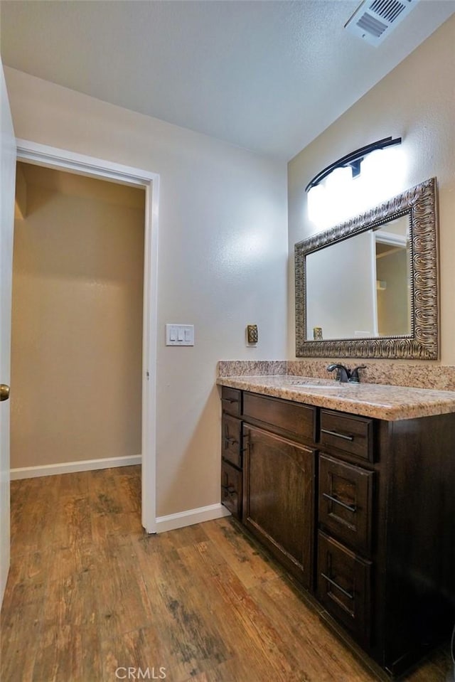 bathroom with vanity and hardwood / wood-style flooring