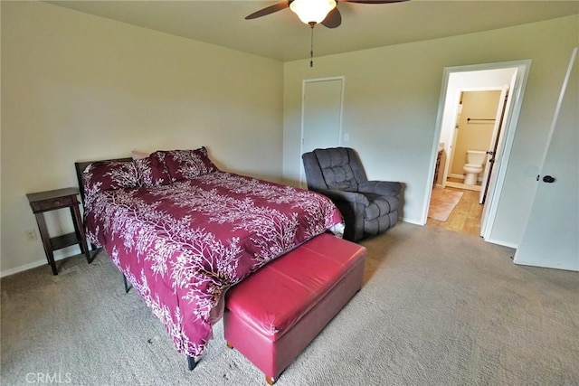 bedroom with ceiling fan, connected bathroom, and carpet floors