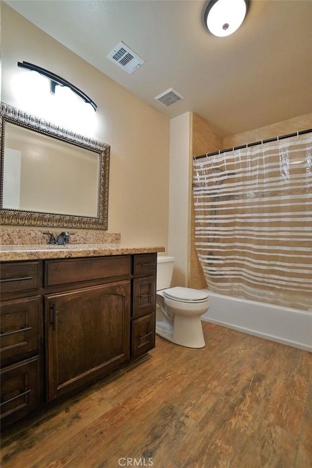 bathroom with vanity, hardwood / wood-style floors, a shower with curtain, and toilet