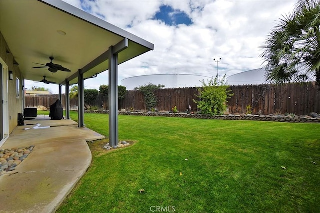 view of yard with a patio area and ceiling fan