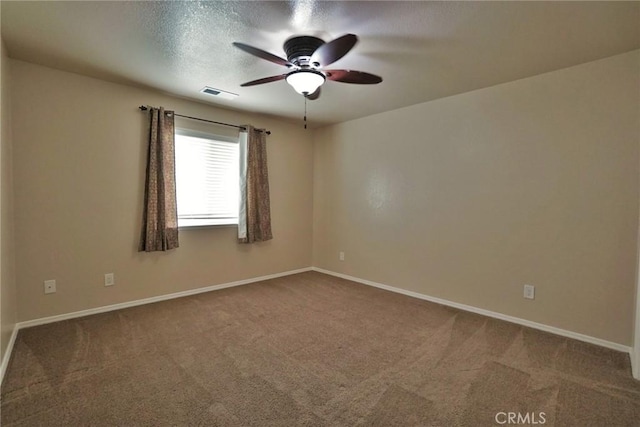 carpeted empty room featuring a textured ceiling and ceiling fan