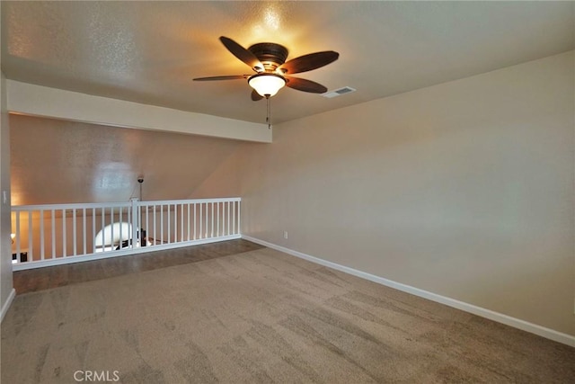 empty room with ceiling fan and carpet